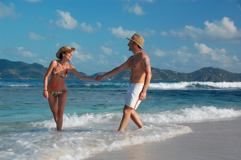 couple strolling in tropical surf